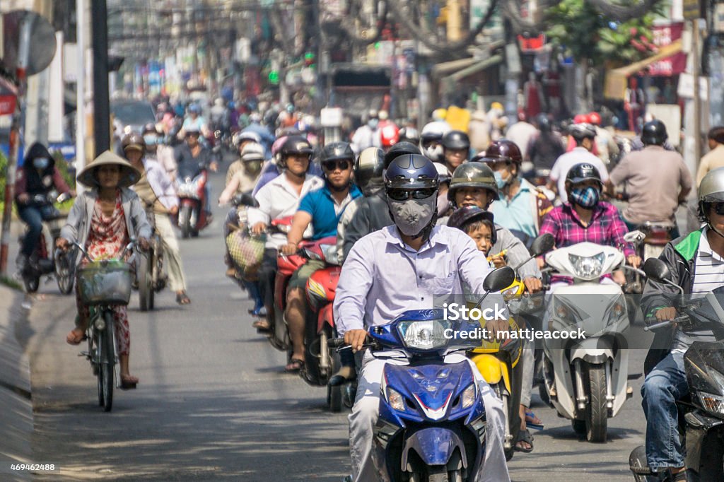 Busy street in Vietnam Lots of people on mopeds and scooters in Ho Chi Minh city. Ho Chi Minh City Stock Photo