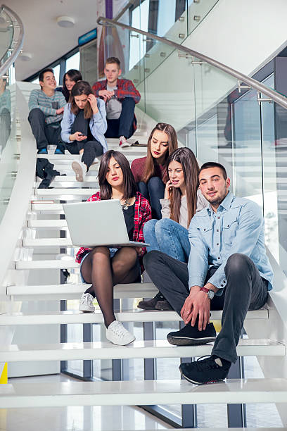 istock Medium group of  students studying on steps of school building. 469465878