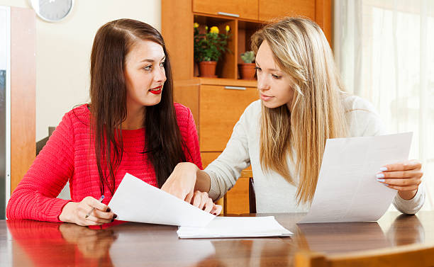 istock serious women looking financial documents 469465898