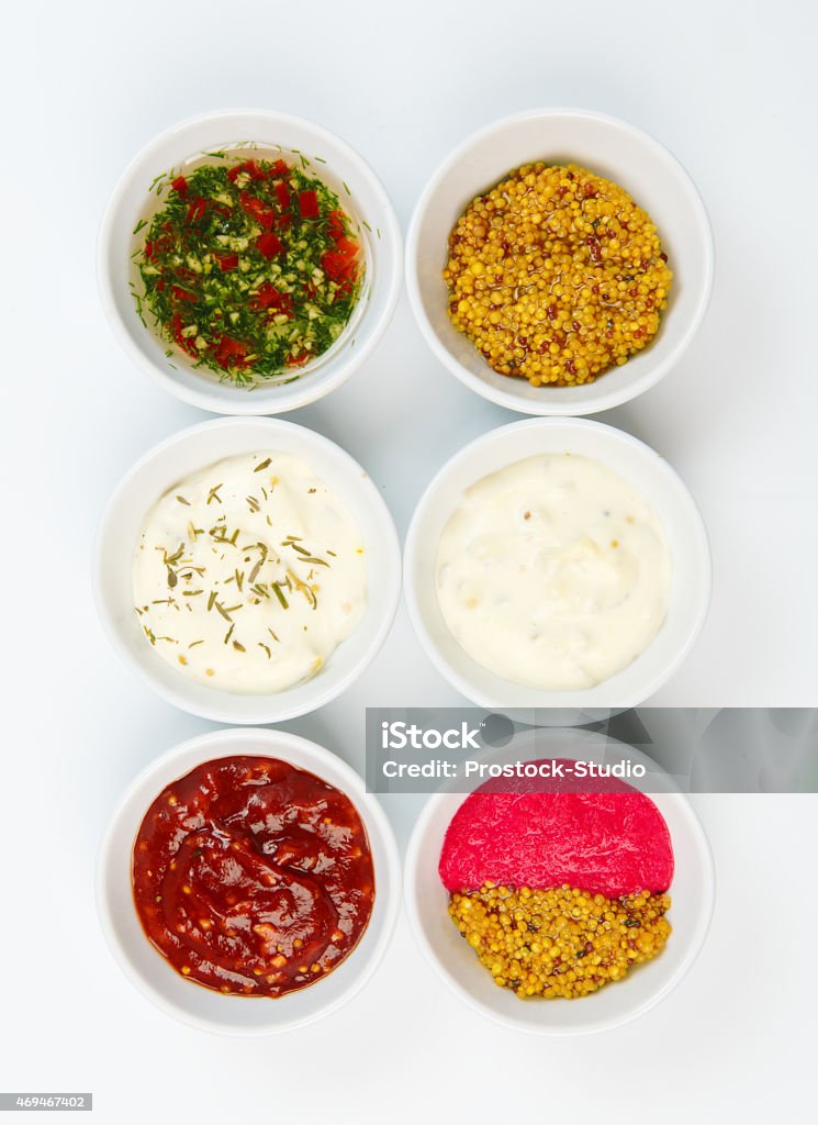 Variety of sauces in white bowls Variety of sauces in white bowls isolated Bowl Stock Photo