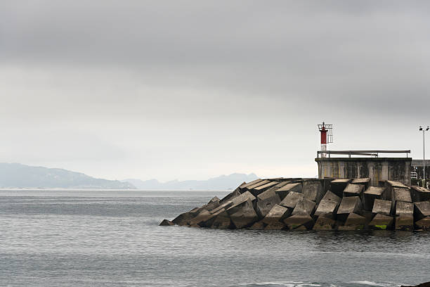 istock White and red small lighthouse in Galicia 469474782