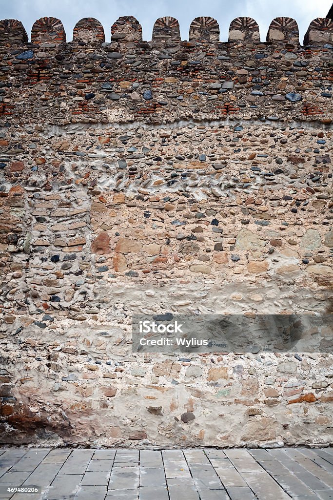 Wall of stones Wall of stones and pavement Textured Stock Photo