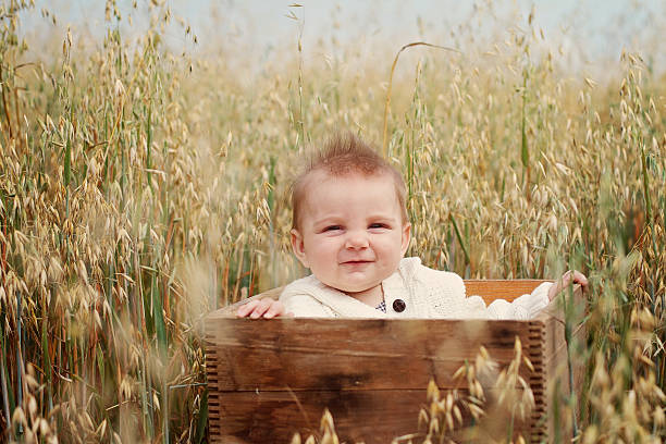 istock Beautiful 8 months old baby smiling in a field. 469480470