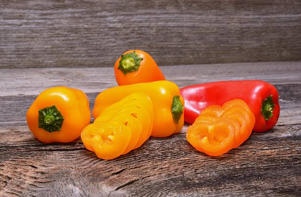istock sweet peppers on wooden table background 469480750