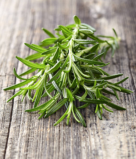 istock Rosemary on a wooden background 469488156