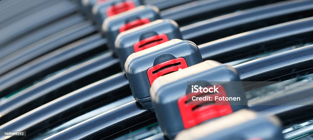 Shopping carts Close up of shopping carts with coin operated lock lined up in a row ready for use. Coin Operated Stock Photo