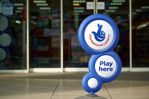 National Lottery sign London, UK - April 7, 2015: Blue National Lottery sign, showing its crossed fingers logo, in front of shop entrance. national landmark stock pictures, royalty-free photos & images