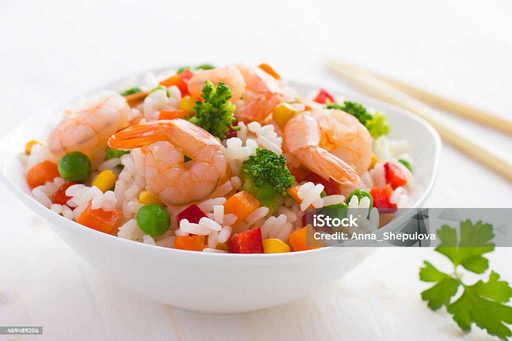 Rice with vegetables and shrimps Rice with vegetables and shrimps on white background Basmati Rice Stock Photo