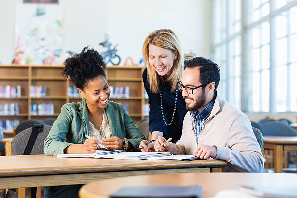 istock Diverse group of adult students studying in modern college library 469493000