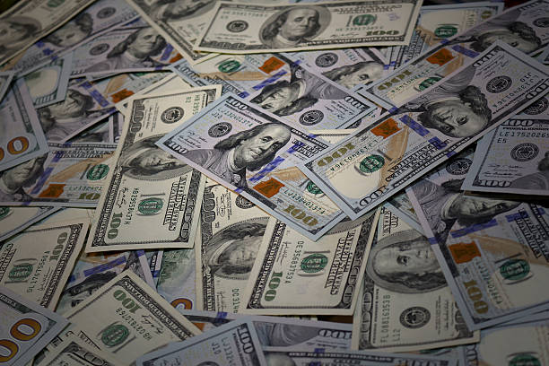 istock One hundred dollar bills in a pile 469503506