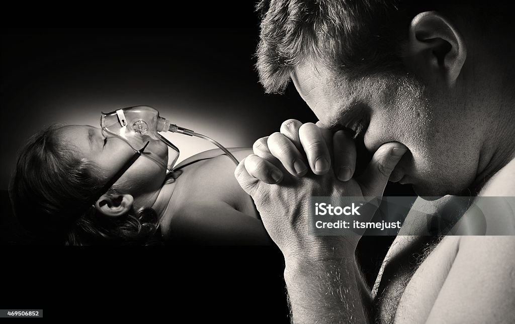 Father prays for the health of seriously ill daughter. Crying Stock Photo