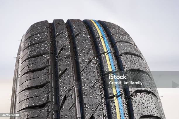 New Car Tire With Water Drops Stock Photo - Download Image Now - 2015, Black Color, Car