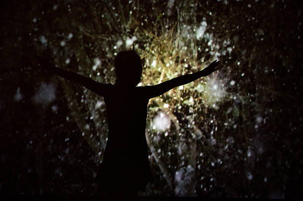 istock Girl opens arms for mystery scene shown by screen 469507459