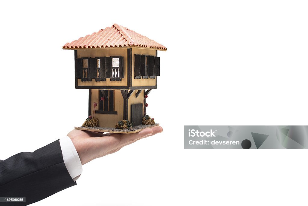 House For You Businessman holding a model house. Mansion Stock Photo