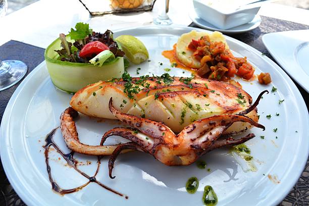 istock Grilled calamari and vegetables on the white plate 469510588