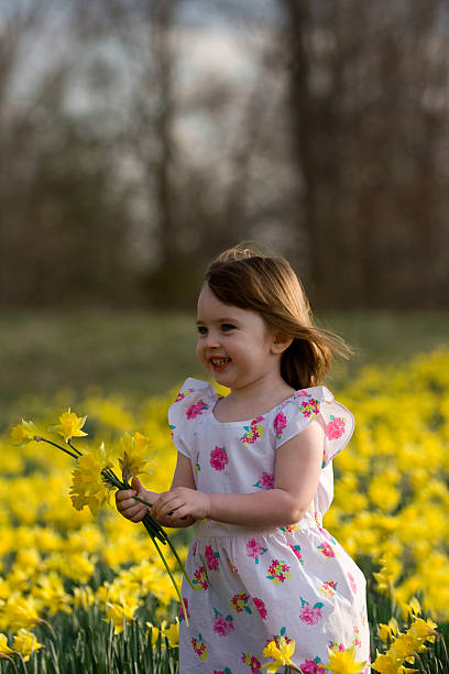 istock Little girl with flowers 469513648