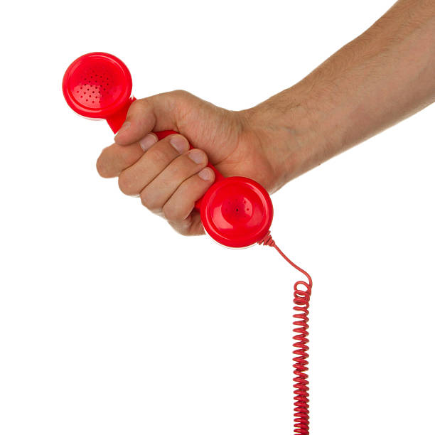 istock Man holding a red telephone 469514545