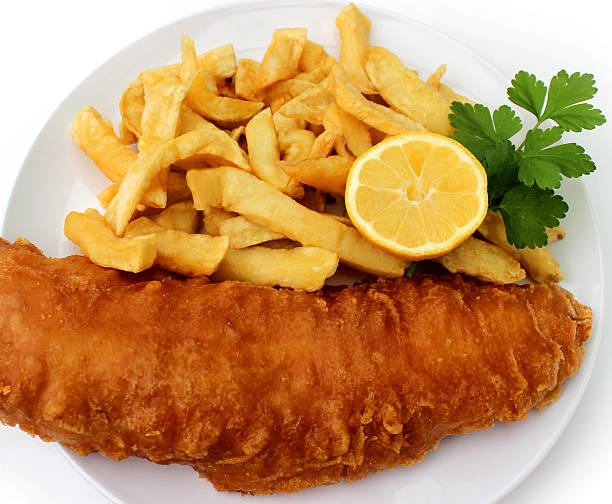 istock Image of battered cod, fish and chips on-plate, lemon, parsley 469521372