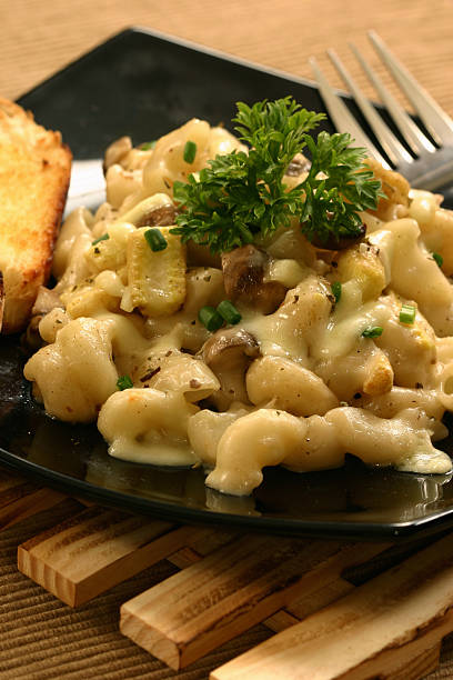 makkaroni, pilz & baby corn in weißen sauce - macaronies stock-fotos und bilder