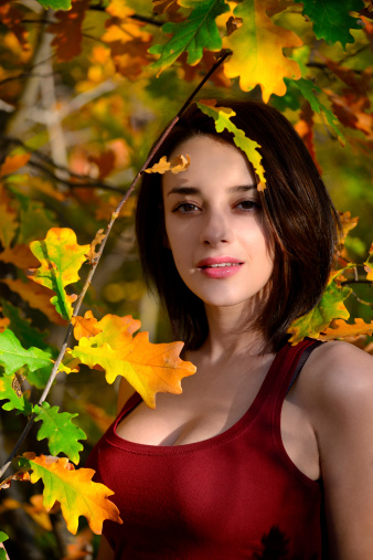Beautiful Young Woman Between Leaves