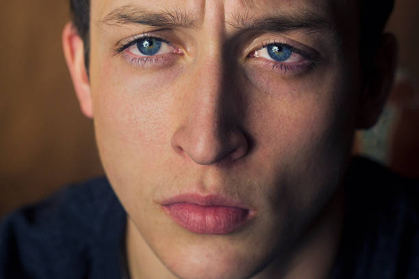istock Blue eyed young man looking sad 469523085