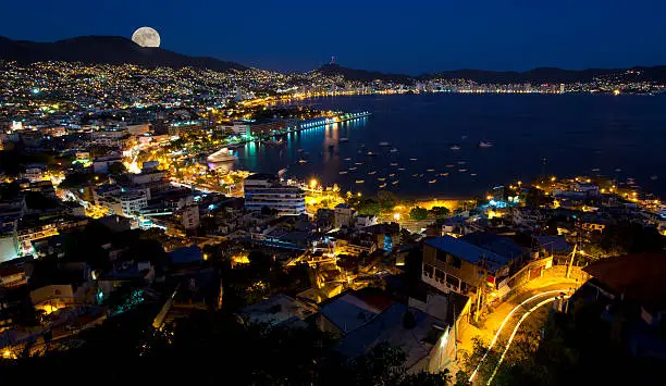 Aerial view of Acapulco Mexico with the moon rising