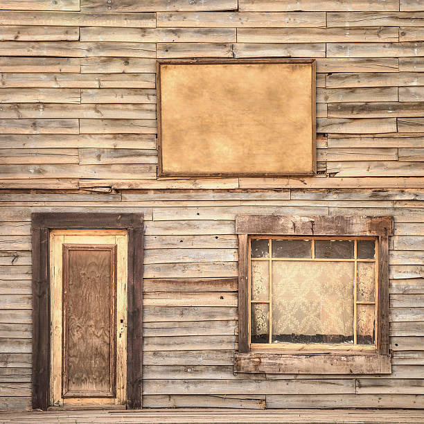 Western vintage wooden facade background. Door, window and blank board Western vintage ranch wooden facade background or pattern. Door, window and blank or empty board saloon photos stock pictures, royalty-free photos & images