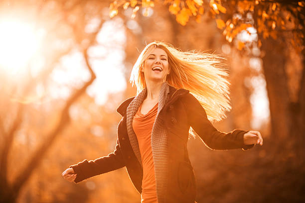 istock Young cheerful woman having fun during autumn day. 469529192