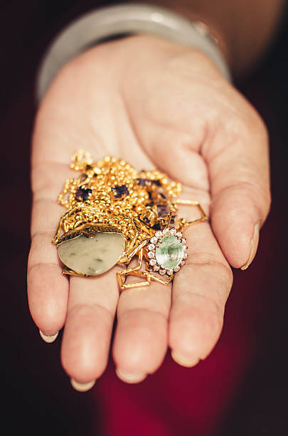 istock Gold ornaments in a hand with vintage filter effect. 469532099
