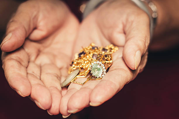 istock Gold ornaments in a hand with vintage filter effect. 469532199