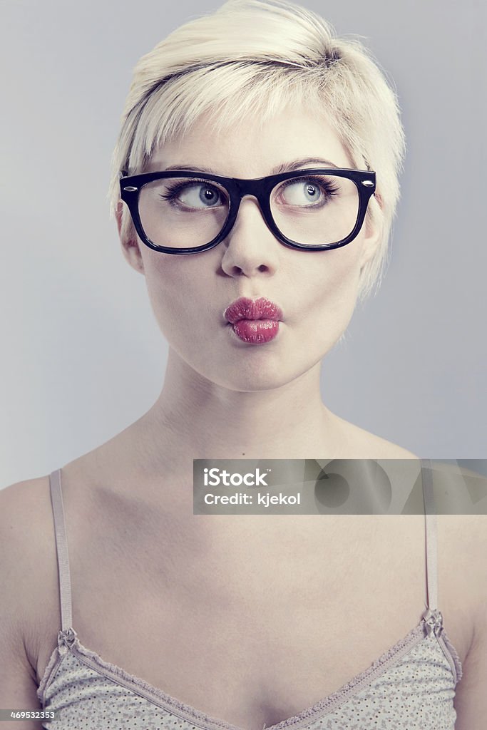 Young woman with glasses Nerdy and thinking girl with horned glasses. Naturally toned. Beautiful Woman Stock Photo