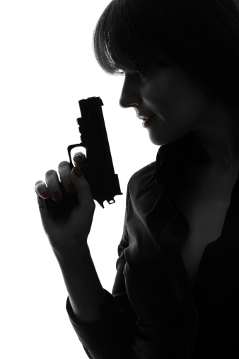 one caucasian sexy detective woman holding aiming gun in silhouette studio on white background