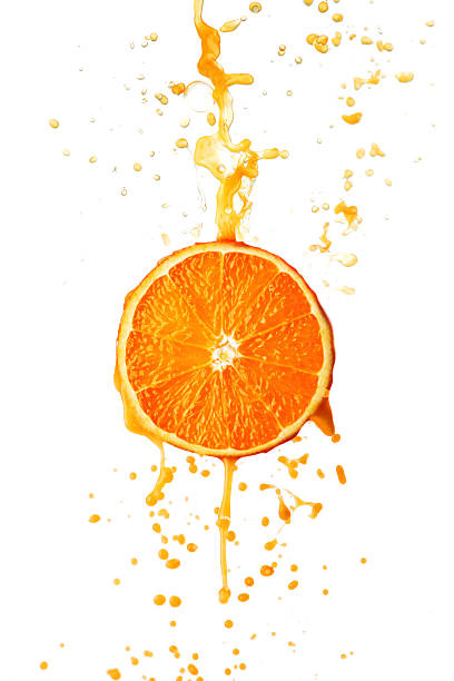 istock Orange juice splashing against white background 469537268