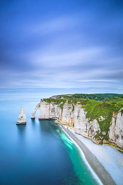 Etretat Aval cliff, rocks and natural arch landmark and blue ocean. Aerial view. Normandy, France, Europe.