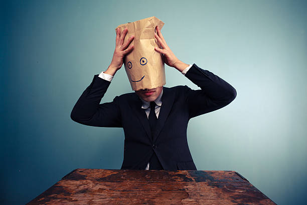 istock Businessman putting a bag on his head 469537821