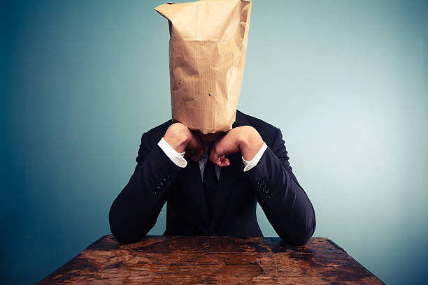 istock Sad businessman with bag over his head 469537847