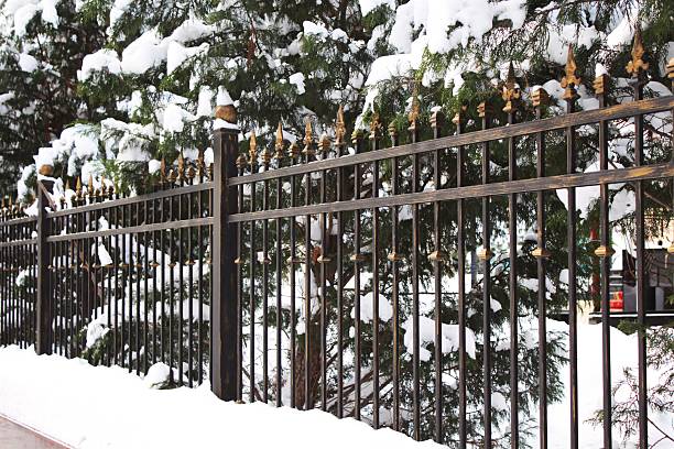 istock Black cast iron fence in winter day 469539131