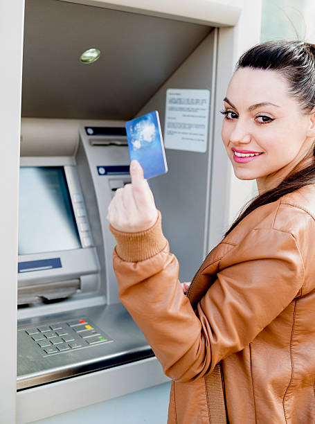 istock Young woman using a cash machine 469543618