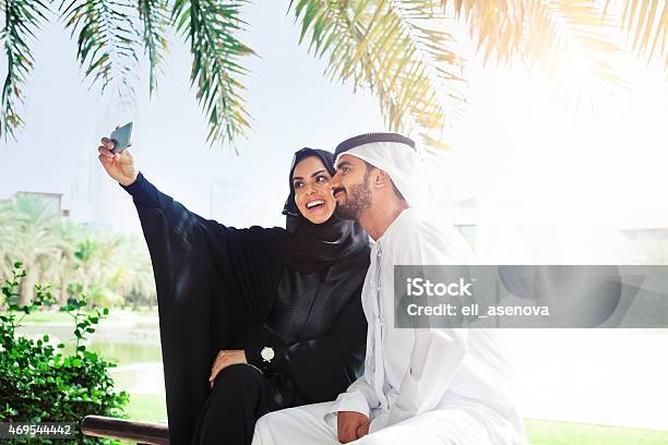Traditional Emirati Young Family Taking A Selfie Stock Photo - Download Image Now - 2015, Abaya - Clothing, Addiction