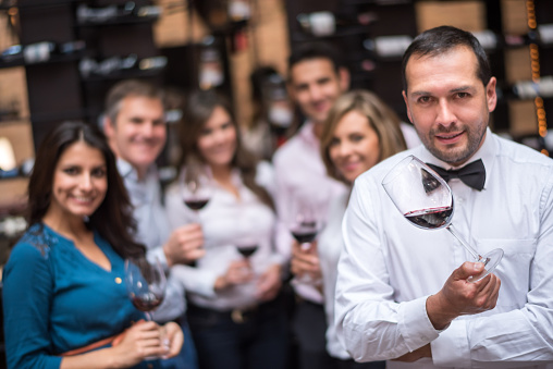 Group of people holding glasses of wine at a winetasting