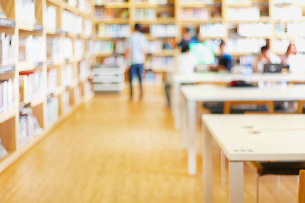 Blurred background of modern library with bookshelves