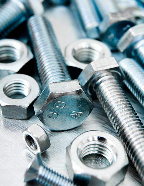 istock Nuts and bolts on scratched metal background 469544992