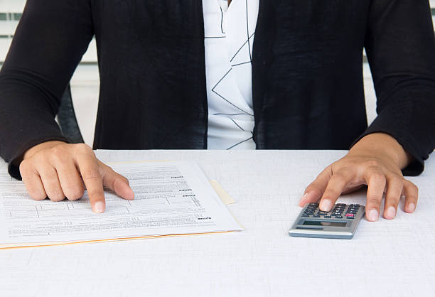 istock Business woman working on financial data with calculator 469545200