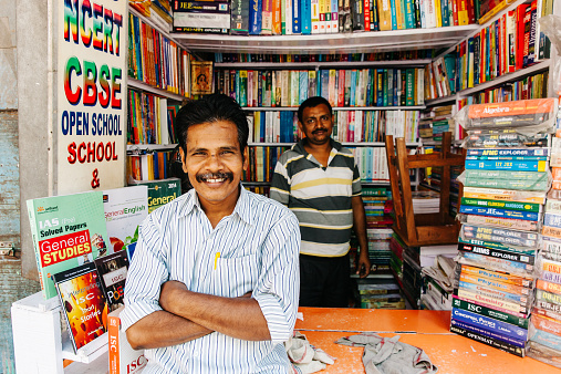 Kolkata, India - March 6, 2014: Men selling used books at the largest second-hand book market in the world on College Street in Kolkata, India