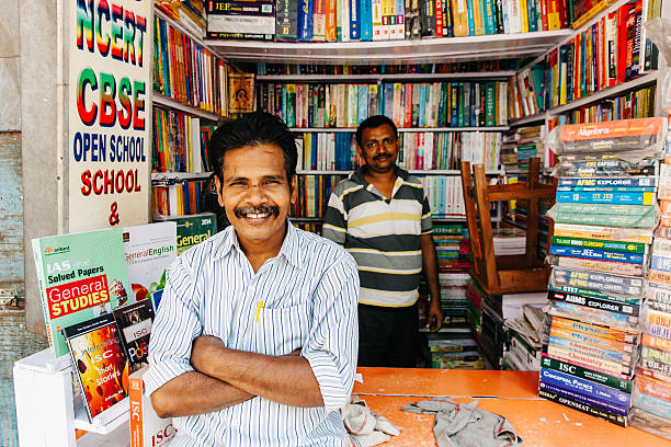 India: Kolkata College Street Second-hand Book Market Kolkata, India - March 6, 2014: Men selling used books at the largest second-hand book market in the world on College Street in Kolkata, India india indian culture market clothing stock pictures, royalty-free photos & images