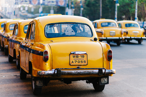 Kolkata, India - March 6, 2014: A street full of the famous yellow british taxi cabs of Kolkata, India