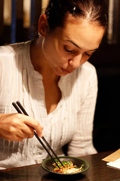 istock Woman Eating Fried Noodle 469546887