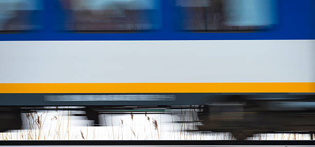 istock Train moving fast over a railroad through nature 469548572