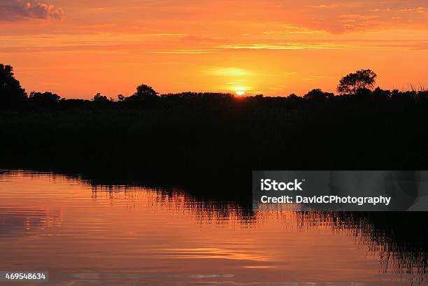 Norfolk Broads Setting Sun Reflection Stock Photo - Download Image Now - Sunset, 2015, Dusk