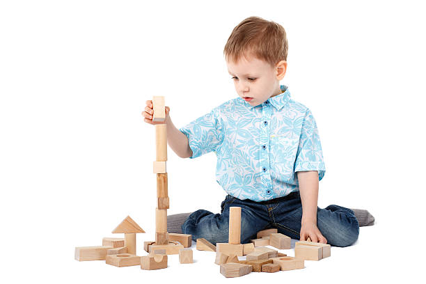 istock Little boy playing with wooden designer on the floor 469549178